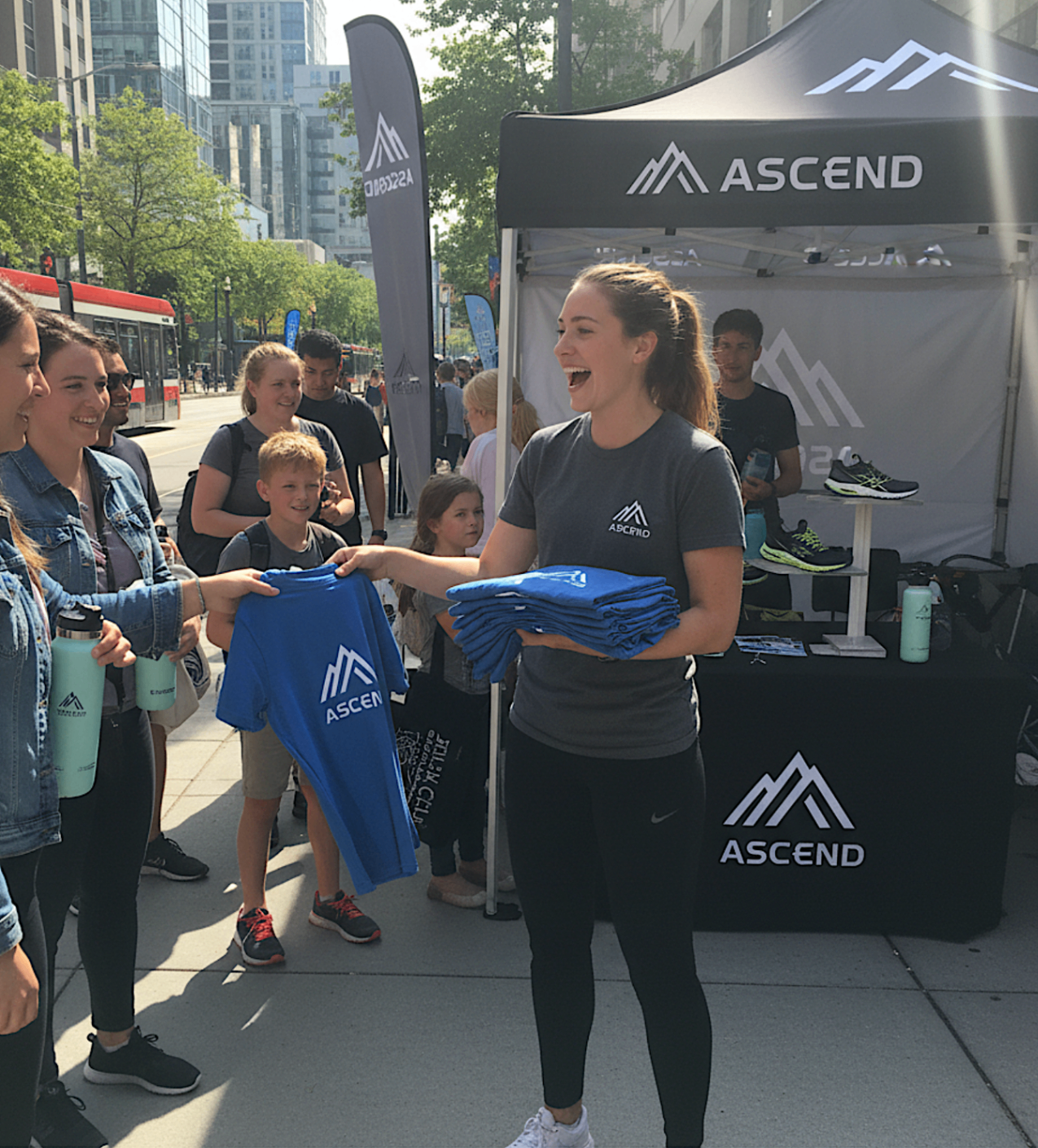 Brand ambassador handing merchandise to guests at a city activation stand